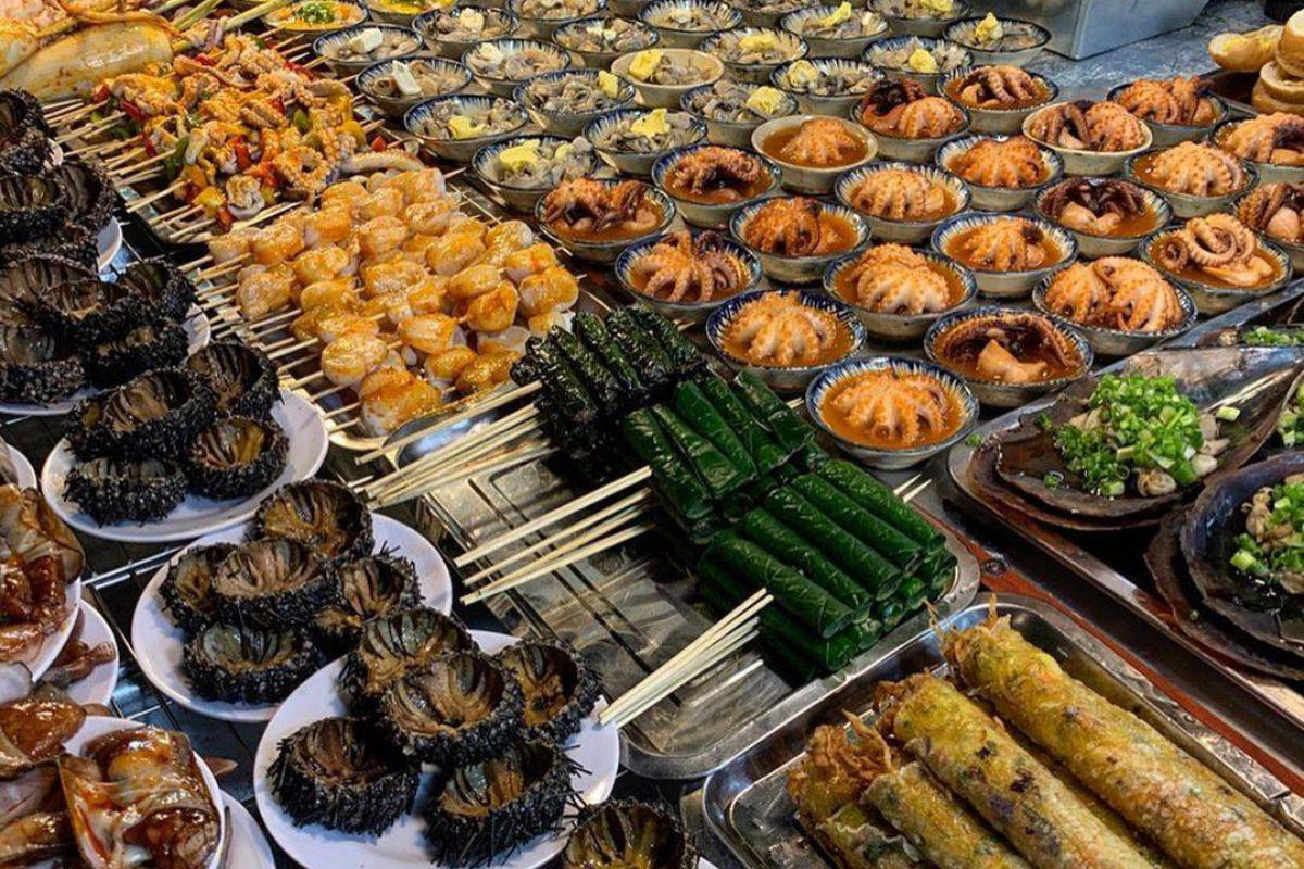 Grilled seafood and Vietnamese snacks displayed at a street food stall in Nha Trang Night Market